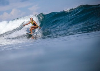 Female surfer riding wave