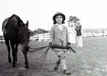 A young Jackie Bouvier leading her Pony