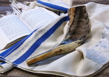 Shofar horn on white prayer talit for Rosh Hashanah