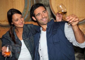 11456598 – smiling man and woman tasting wine in a cellar