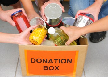 People putting food in a donation box