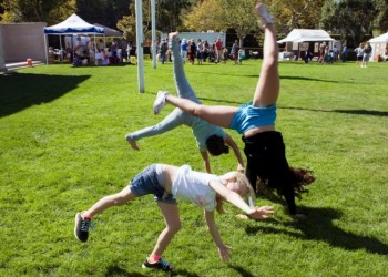 Three girls, Natalie Samlihan age 5, Rachel Barrale, age 12, and Amanda Lobalsamo, age 12, were so happy they were cartwheeling on the green grass amid the SeptemberFest festivities.