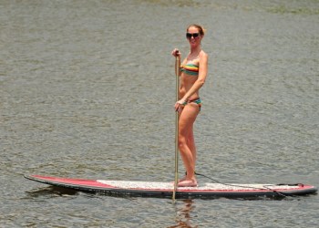 Woman getting exercise by paddleboarding