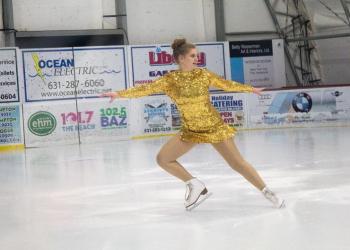 Kaylee Mendelman is glitzy in gold as she performs to 