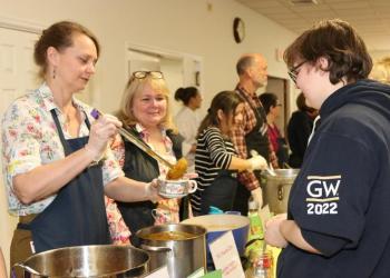 Volunteer Jen Edwards serves delicious soup to Will, age 17