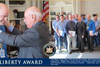 Senator Kenneth P. LaValle with NY State Liberty Award recipient, David Lopez and the team that kept Southampton Hospital up and running during and after Hurricane Sandy. Front Row: James White, NYS Senator Ken LaValle, David Lopez,Director of Facilities Management and Engineering Middle Row: Jordan Gomez, Rich Donohue, Mike Catalano, Robert Chaloner -- President and Chief Executive Officer of Southampton Hospital Back Row: Gary Scherpich, Tom Goetz, Tom Lawlor, Tom Colitti.