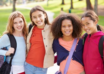 Group Of Young Girls Hanging Out In Park Together