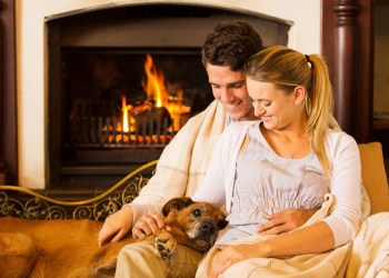 Couple with dog by fire