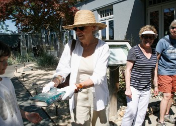 People pass the last book to go into the newly renovated John Jermain Memorial Library down Sag Harbor’s Main Street last Saturday