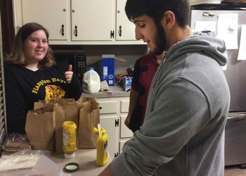 Hampton Bays High School Leo Club members Zoey Smith and Michael Del Rey prepare food for Maureen’s Haven