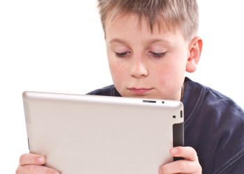 Teen plays on the tablet computer