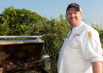 Ash Fulk of Hill Country BBQ tending a grill full of tri-tip