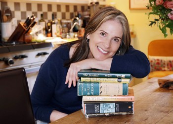 Susan Merrell at home with her with books in Sag Harbor