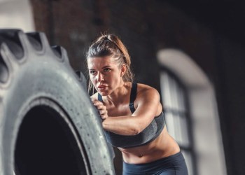 CrossFit woman pushing tire