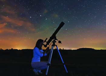 47066493 - woman looking through a telescope watching the stars. woman under night sky, constellations, draco, ursa major, big dipper, botes