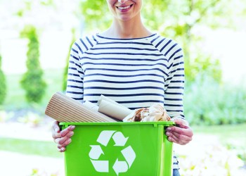 Woke woman separated paper from other waste to green container to save natural resources, Hamptons recycling