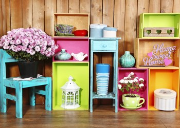 35872956 - beautiful colorful shelves with different home related objects on wooden wall background