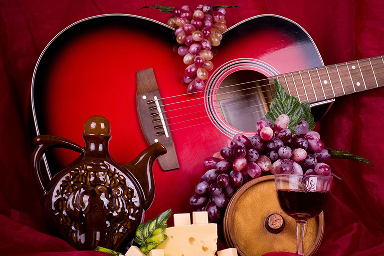 12376872 - beautiful composition with wine, grape, cheese and guitar on red background