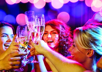 party, holidays, celebration, nightlife and people concept - smiling friends with glasses of champagne in club smiling friends with glasses of champagne in club