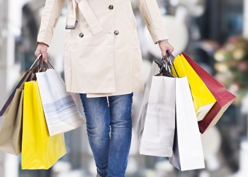 woman walking with shopping bags with christmas background.