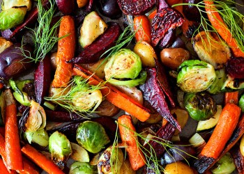 Full background of colorful roasted autumn vegetables, above view