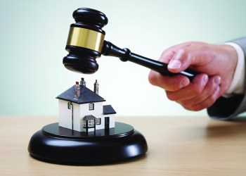 Bidding on a home, gavel and house concept for home ownership, buying, selling or foreclosure