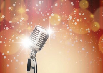 Retro microphone over the Abstract photo of Christmas and blurred background, vintage musical concept