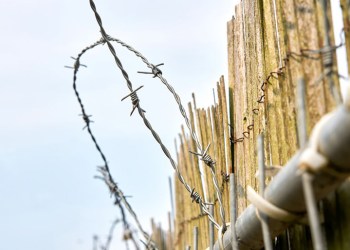 Barbed wire prison fence