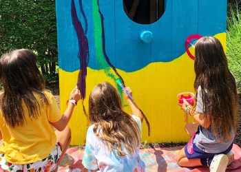 Shine campers painting a birdhouse