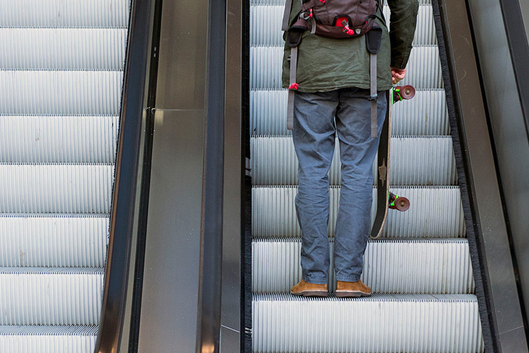 Skateboarder on Hamptons Subway escalator