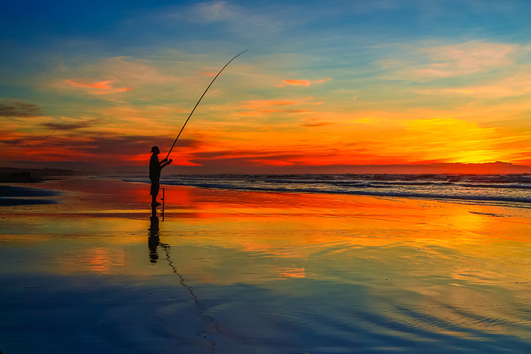 Surfcaster at sunset