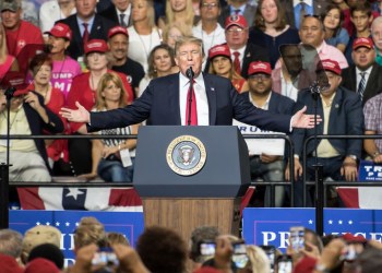 Donald Trump spreadds his arms out in front of a huge crowd at his Tampa, Florida rally on July 31, 2018