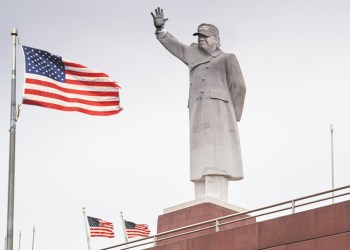 Statue of Donald Trump as dictator with American flags blowing in the wind - a world where third terms are OK