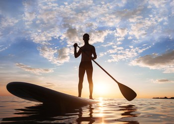 paddle standing, silhouette of man on the beach at sunset