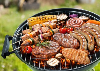 Assorted delicious grilled meat with vegetable over the coals on a barbecue