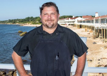 Matty Boudreau standing with hands on hips on the deck at The Halyard at Sound View Greenport