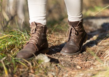 feet in shoes on a forest path