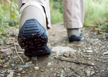 Cropped rear view of a hiker walking along a trail