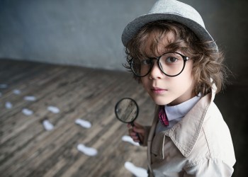 Little detective with a magnifying glass