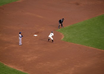 Baseball players standing at least six feet apart