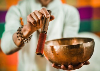 therapist using tibetan singing bowl in sound therapy