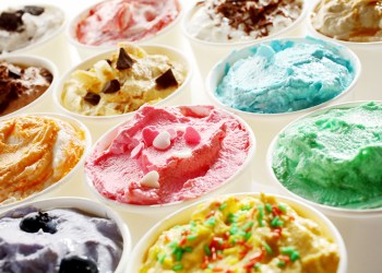 Display of tasty summer ice cream in different flavors and colors served in individual tubs viewed obliquely for advertising for a parlour or ice cream shop