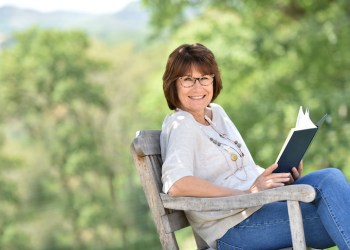 Senior woman reading book outside