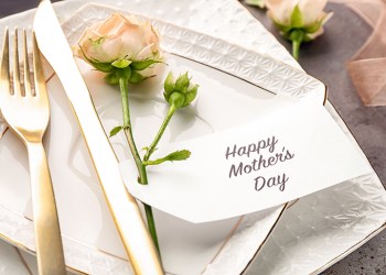 Elegant table layout for dinner with flowers and greeting card