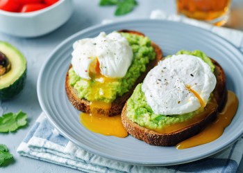 Poached egg Avocado Rye Toasts on a stone background. toning. selective focus