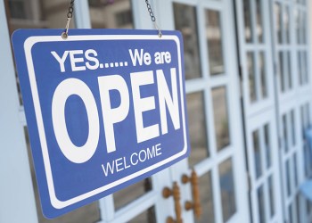 yes we're open sign on the blue doors in store. welcome sign at the store