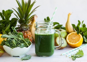 Fresh kale fruit smoothie in a jar with ingredients