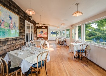 Old Stove Pub's indoor dining space, with picnic tables in the distance, Photo: Courtesy Starlet PR