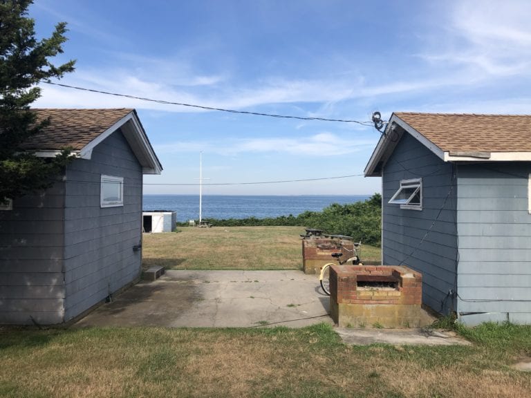 FOUR RAMSHACKLE COTTAGES WITH AN UNOBSTRUCTED VIEW OF FORT POND BAY WILL SOON BE REPLACED BY FOUR HIGH-END RESORT UNITS.