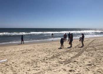 A POLICE TAPE CORDONED OFF AN AREA WHERE POLICE WERE LAUNCHING DIVERS AND JET SKIS TUESDAY AFTERNOON IN SEARCH OF THE MISSING SWIMMER.